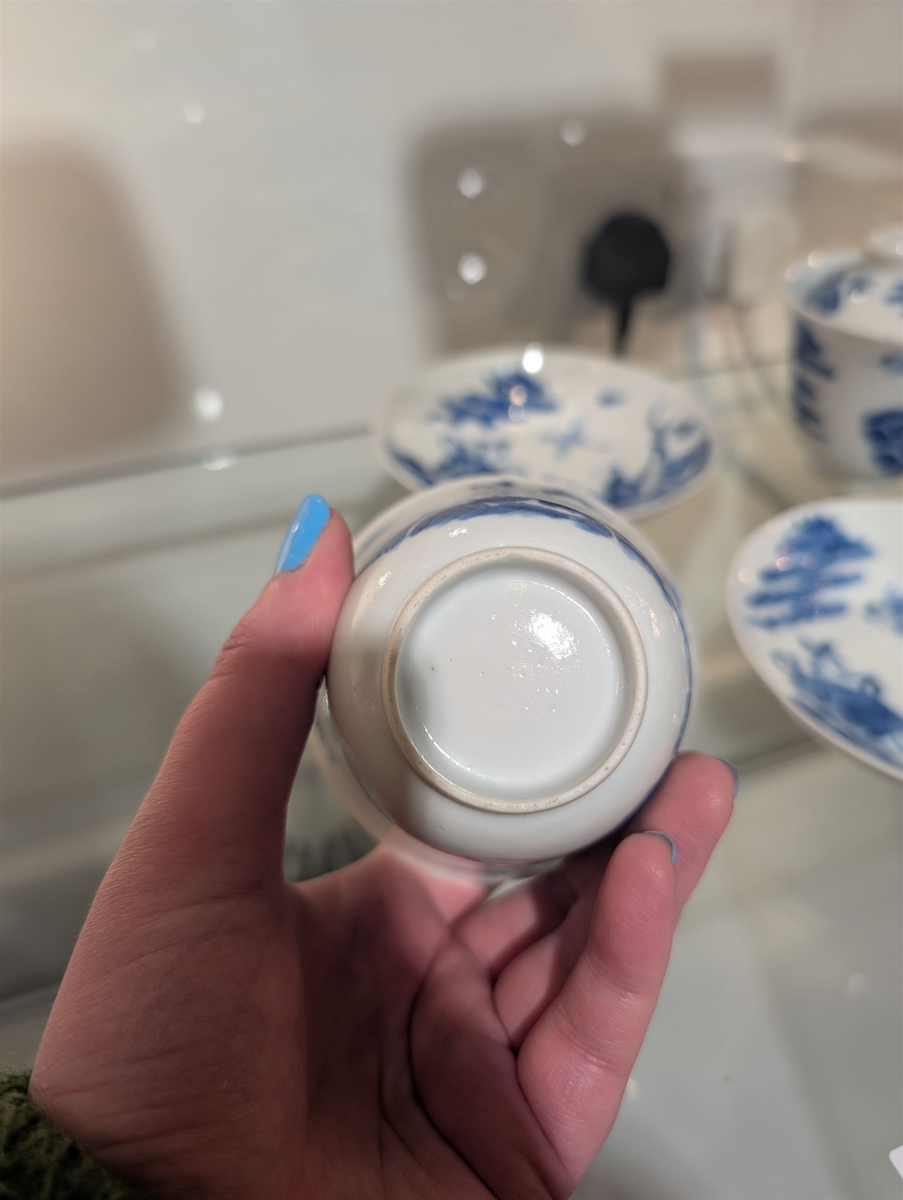 Pair of Chinese blue and white tea bowls, one with cover and four saucers, depicting two figures on a boat at sea, tea bowl H7cm