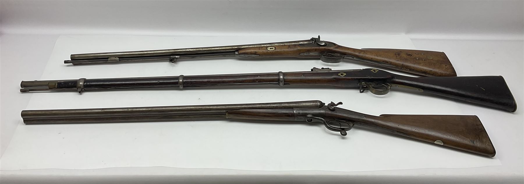 19th century Indian .577 Enfield muzzle loading rifle, proofed for 26-bore, the 98.5cm barrel with three barrel bands and later ram rod L140cm overall; 19th century Belgian side-by-side double barrel percussion shotgun, approximately 20-bore, with 74cm barrels and studded walnut stock, lock plate marked 'Liege 1868' and 'V. Gulikers-Maquinay' L117cm overall; and another side-by-side double barrel shotgun by Smythe with underlever opening (3)