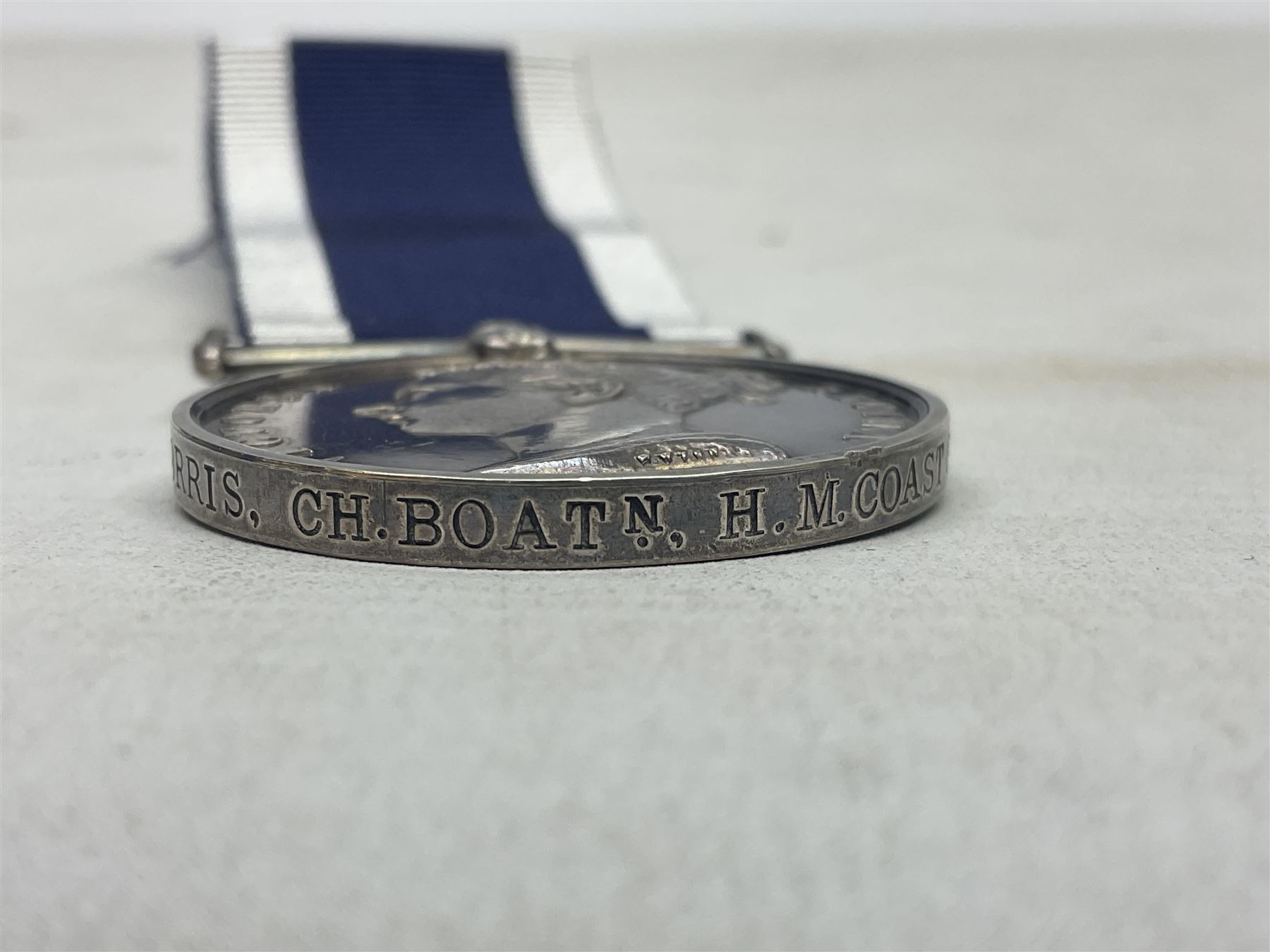 Victoria Naval Long Service and Good Conduct Medal with narrow suspender, awarded to Chas. Norris, Ch. Boatn. H.M. Coast Guard.; with ribbon