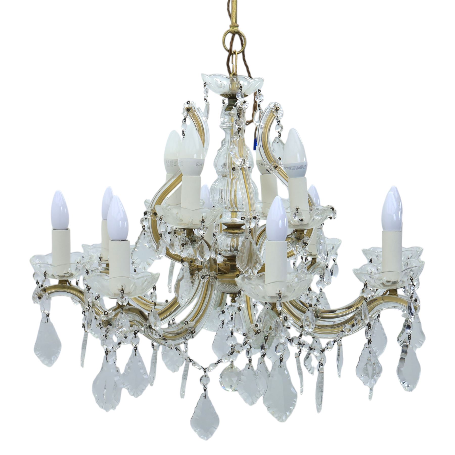 20th century Maria Theresa style twelve branch chandelier, gilt metal frame with scrolling arms clad in moulded glass, the central baluster stem issuing twelve candle sconces with glass drip pans, hung with faceted pendants and swags of cut glass beads 