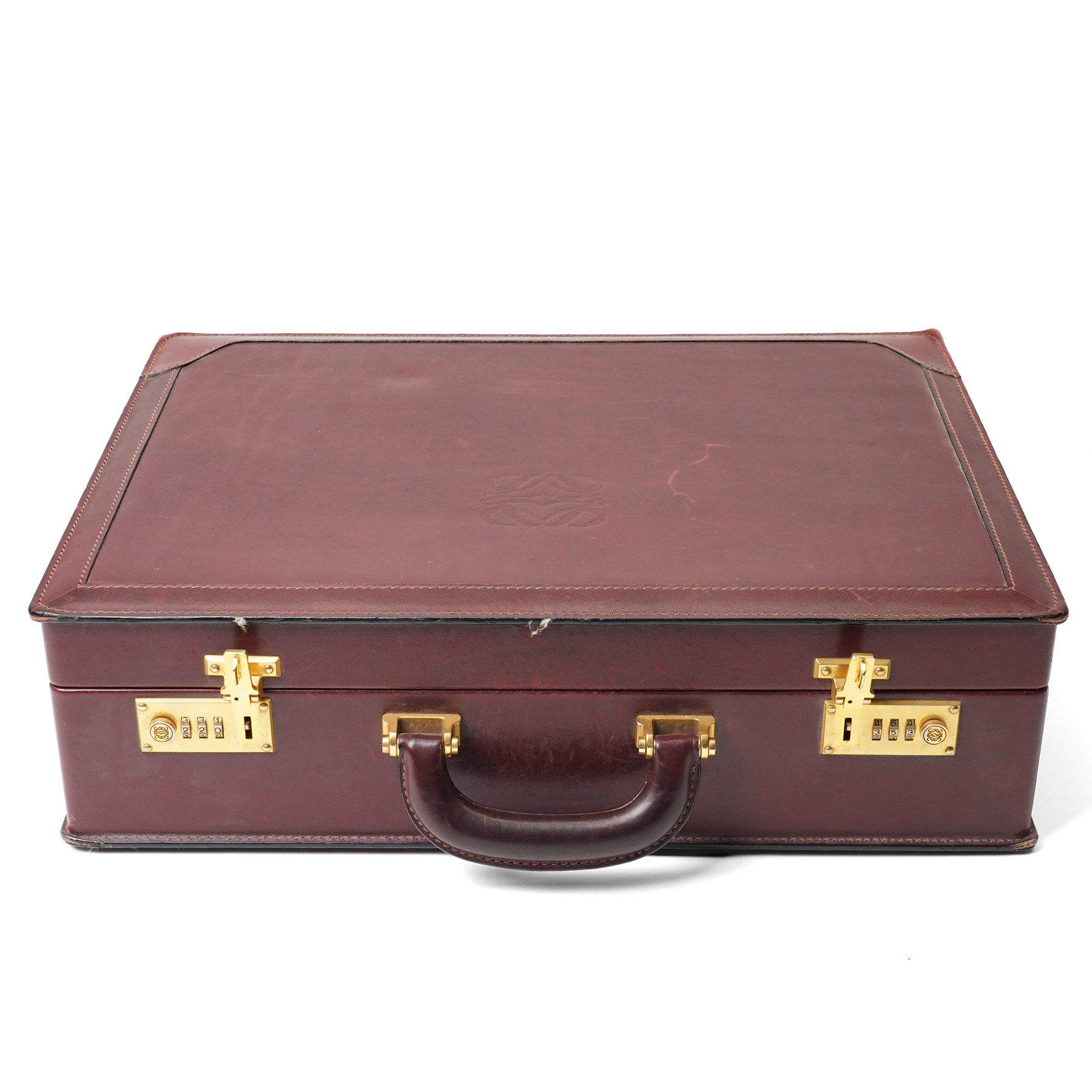 Loewe - vintage burgundy leather attaché case, the exterior embossed with Loewe Anagram, with gilt-tone hardware, twin combination locks and leather handle, opening to a suede-lined fitted interior with document compartments, pen loops and pockets, stamped LOEWE Madrid 1846