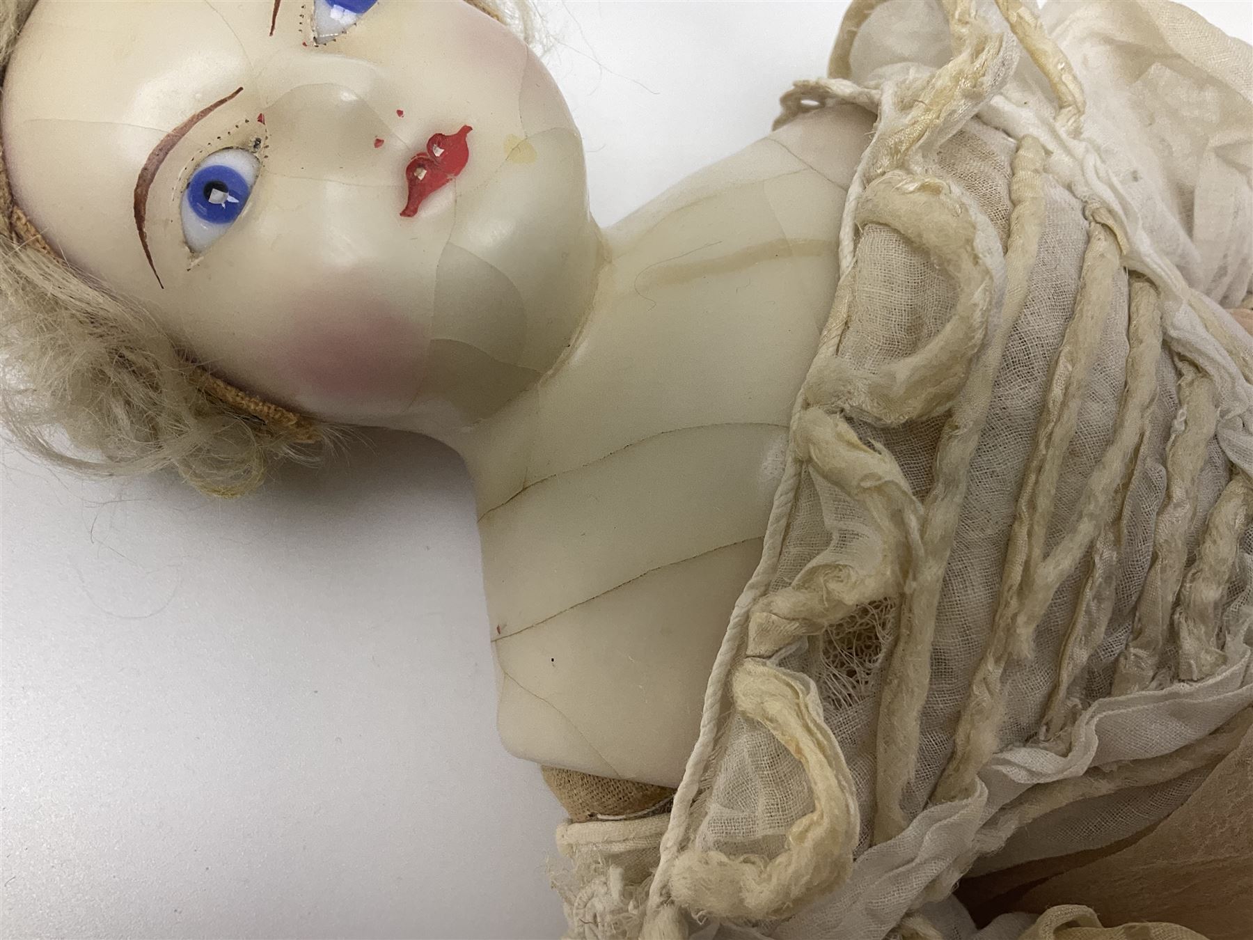 Victorian wax shoulder head doll with pale complexion, applied hair, inset glass eyes and fabric covered jointed body with kid leather lower arms; white linen dress and undergarments H50cm