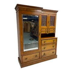 Victorian figured oak and pollard oak combination wardrobe, projecting dentil cornice, the left hand side enclosed by large bevelled mirror glazed door over drawer, the interior with sliding hanging rail, the right hand side with cupboard enclosed by two panelled doors relief carved with urn and trailed trailing foliage, four small drawers over shelf, three drawers and brushing slide, the slide with tooled and gilt blue leather inset, plinth base