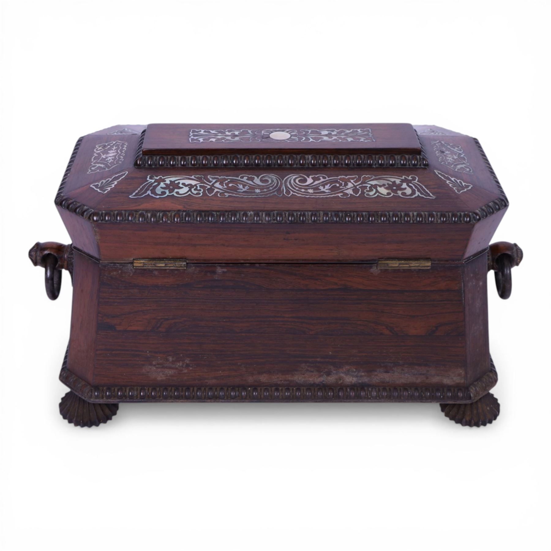 Tea caddy of sarcophagus form, inlaid with mother of pearl decoration,  the hinged lid opening to reveal two covered compartments, H24cm 