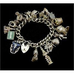 Silver charm bracelet with nineteen charms including poodle, knight, deer, church etc with heart padlock clasp 