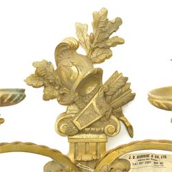 Period design gilt brass wall light, by Beardmore, London, with French empire motifs, including a helmet, oak leaves and acorns, quiver, each arm with acanthus leaf decoration, wired for electricity, with original label, H36cm  
Provenance: property of a Nobleman