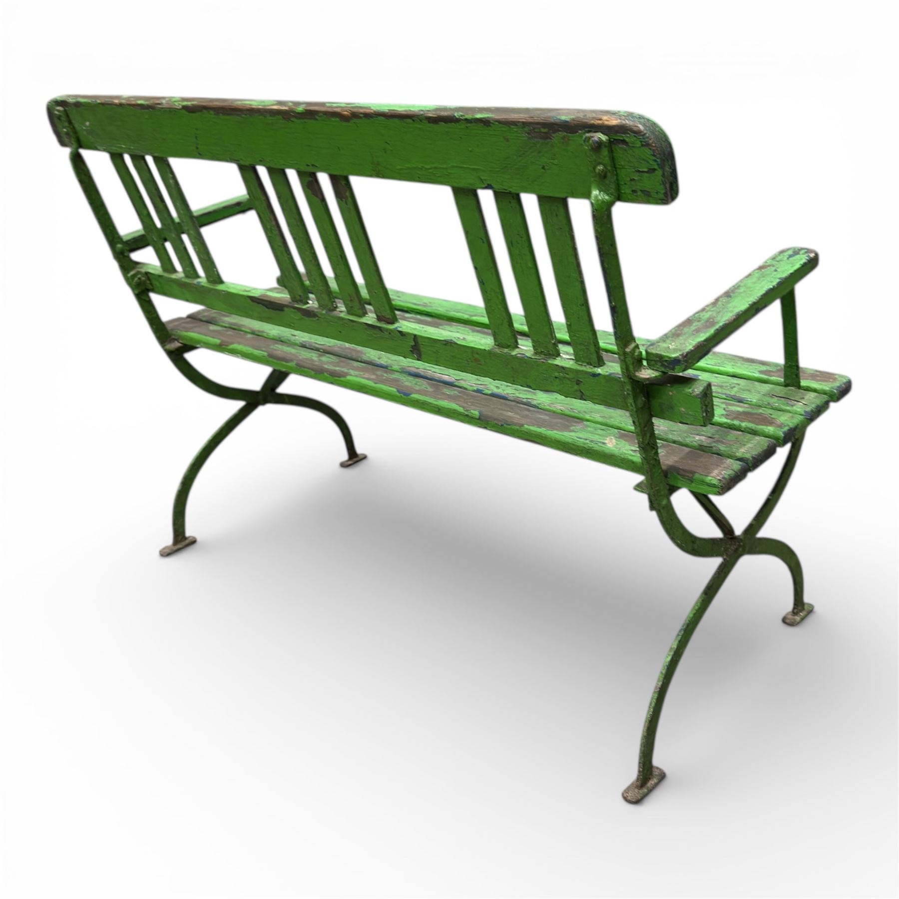 Early 19th century child's garden bench, the wrought iron frame with X frame legs and wooden slatted seat, painted in green, H63cm L90cm D35cm