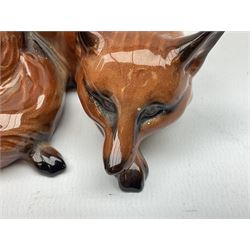 Three Beswick figures modelled as a fox in recumbent pose no.1017, standing fox no.1016a and matte brindle Staffordshire Terrier no.3060, all with printed mark beneath 