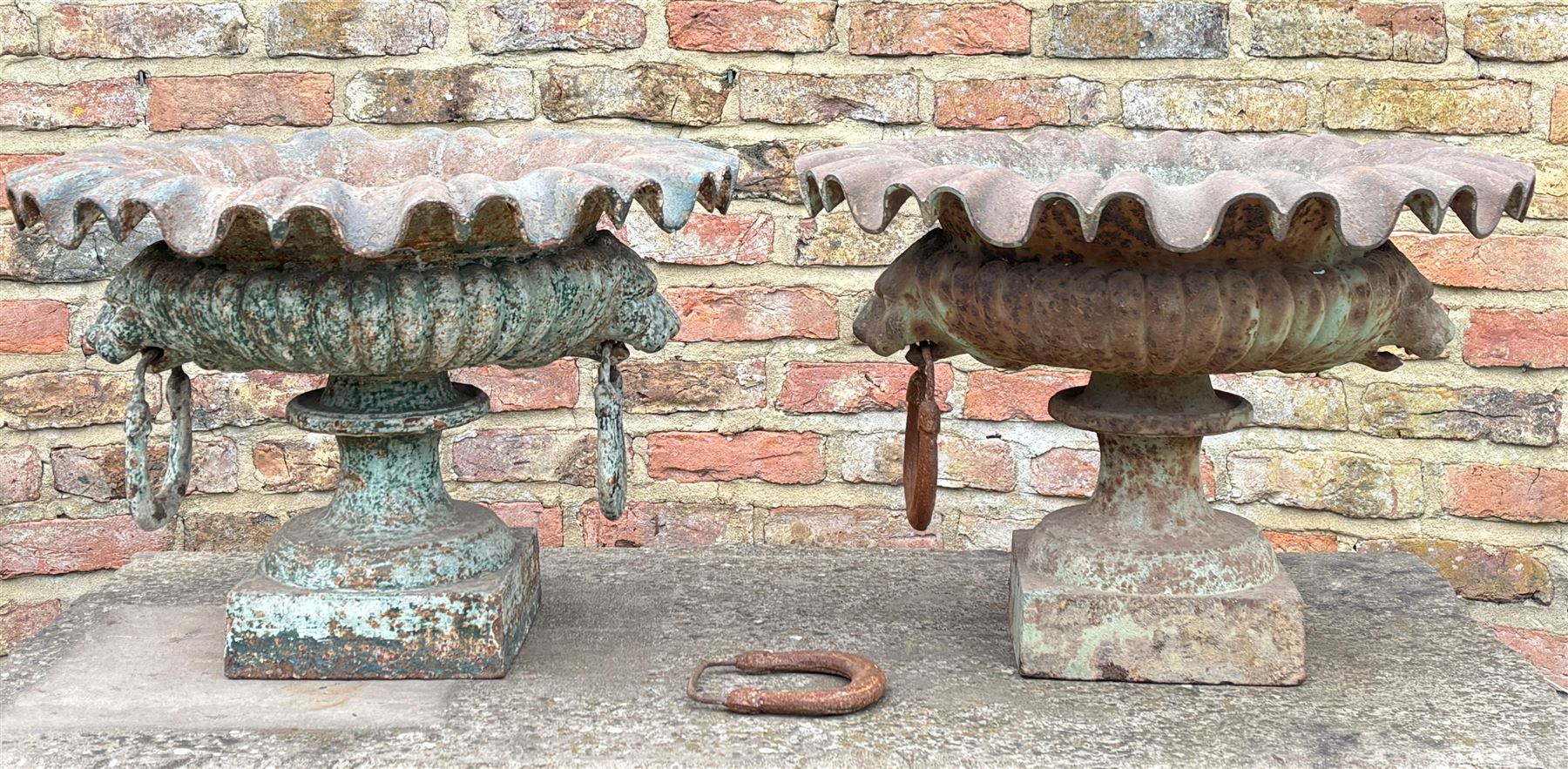 Pair of French cast iron garden urns, each with scalloped edge above lion mask and loop handles, on a square base. H36cm, D73cm.  - COLLECTION BY APPOINTMENT FROM: The White House, Thirsk Road, Easingwold, York, YO61 3NF - CALL 01723 507111 TO ARRANGE