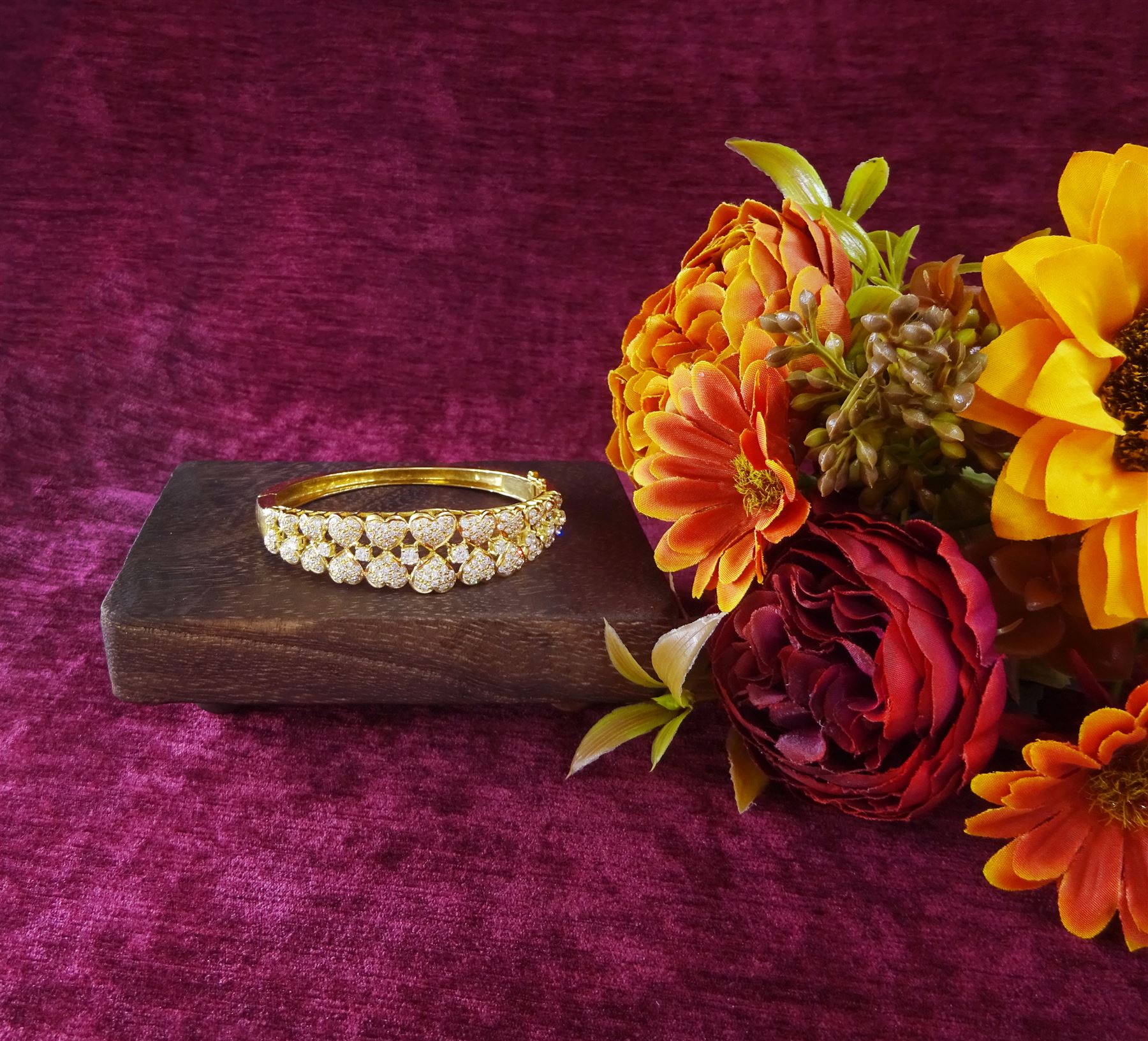 18ct gold diamond heart bangle, two rows of eleven graduating heart motifs, each set with pave set diamonds, spaced by ten round brilliant cut diamonds, total diamond weight approx 1.90 carat