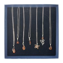 Seven silver Baltic amber pendant necklaces, including octopus and butterfly designs, all stamped 925 