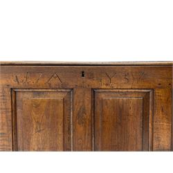 Georgian oak mule chest, moulded rectangular hinged lid over quadruple fielded panel front, the frieze inscribed '17 A Y 57', fitted with two drawers, panelled ends and back, on stile supports