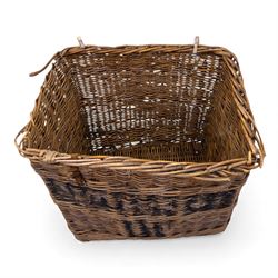 Large 20th century wicker laundry basket, of rectangular form, with stencilled lettering to one sides, raised on wooden base skids