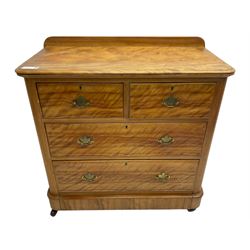 Victorian satin walnut chest, raised back over two short and two long drawers, skirted base with castors