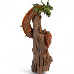 Modern Chinese root carving, modelled as a dragon wrapped round a tree, the dragon painted in greens and reds, H70cm