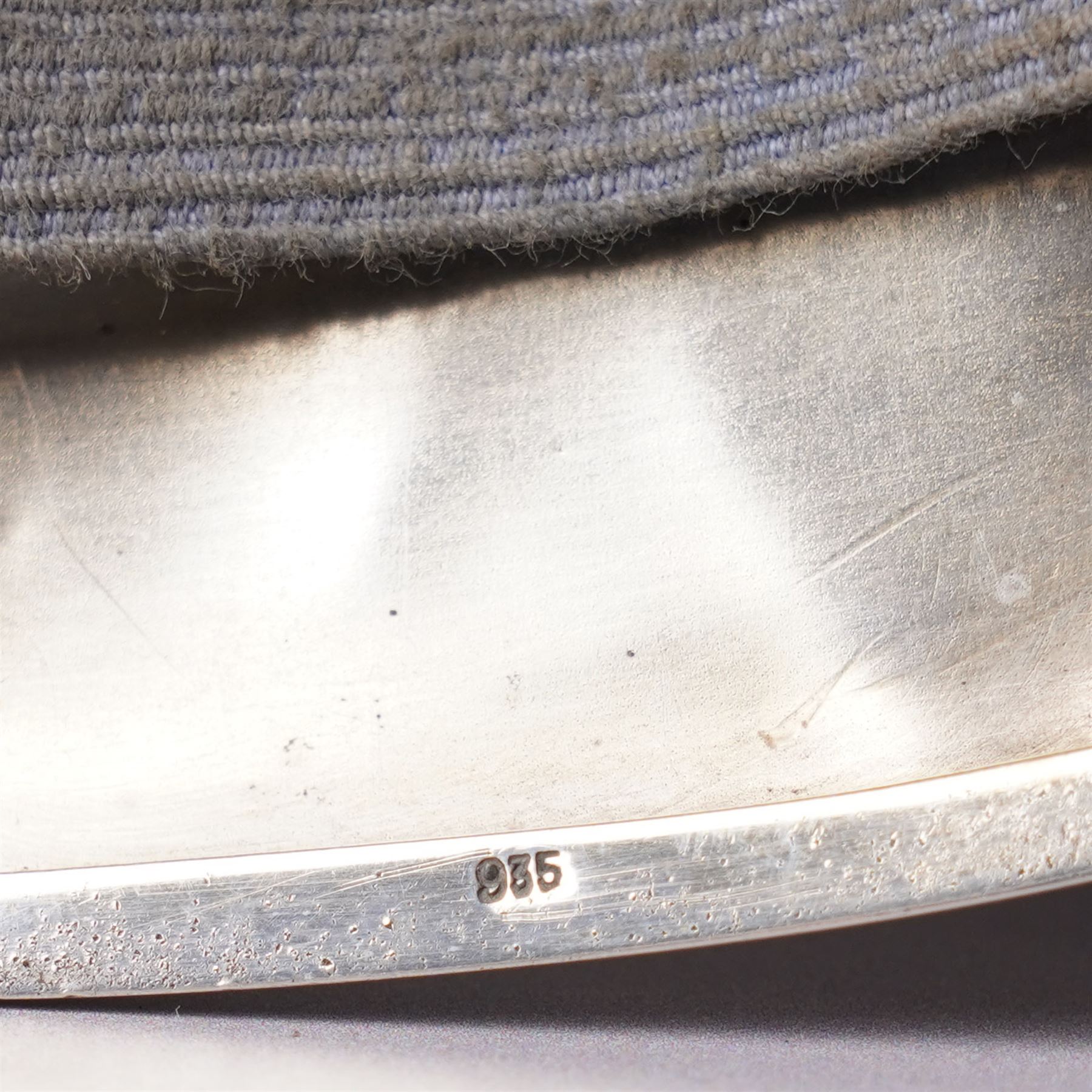 Early 20th century Continental silver and enamel cigarette case of rectangular cushion form, the front enamelled with a capercaillie in a Scottish woodland scene, marked 935, 9cm in length