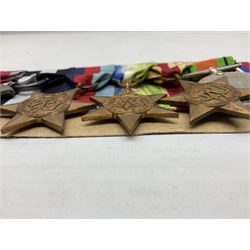 WW2 Royal Naval group of eight medals comprising OBE, hallmarked silver Distinguished Service Cross inscribed verso Lieut. J.R. McCluskie RNVR 1945, 1939-1945 Star, Atlantic Star, Africa Star, 1939-1945 War Medal, Defence Medal and Royal Naval Patrol Service Medal inscribed Lieutenant J.R. McCluskie Royal Naval Patrol Service; with seven original photographs of a sea battle 27th November 1940 against the Italian Fleet and another photographic postcard of Sir Stafford Cripps arriving on board one of the vessels.