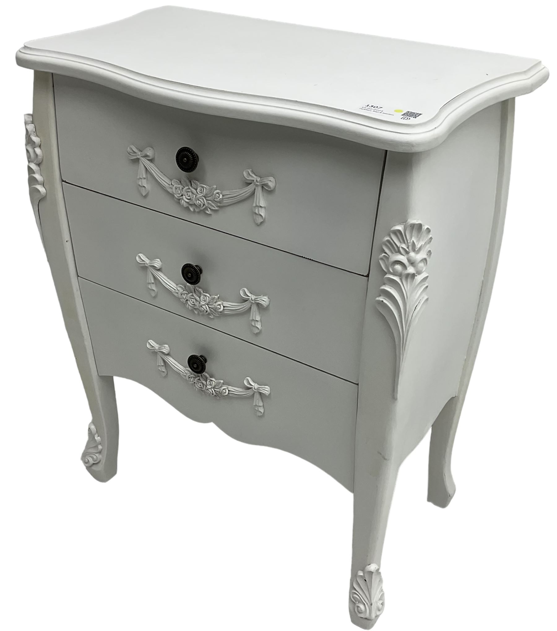 French design white painted chest, shaped top over three drawers, each with applied swags with flower heads, flanked by cabriole uprights with foliate mouldings