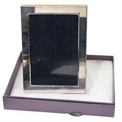 Set of six dessert knives and forks with silver collars and mother of pearl handles, silver plated photograph frame and travelling toilet set in leather case