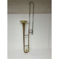 Three brass trombones comprising Elkhart Ind. USA 'CONN' model no.72H; Besson 'Concord'; and Selmer Distributed 'Lincoln'; two in carrying cases; and German B & M 'Champion' brass trumpet (4)