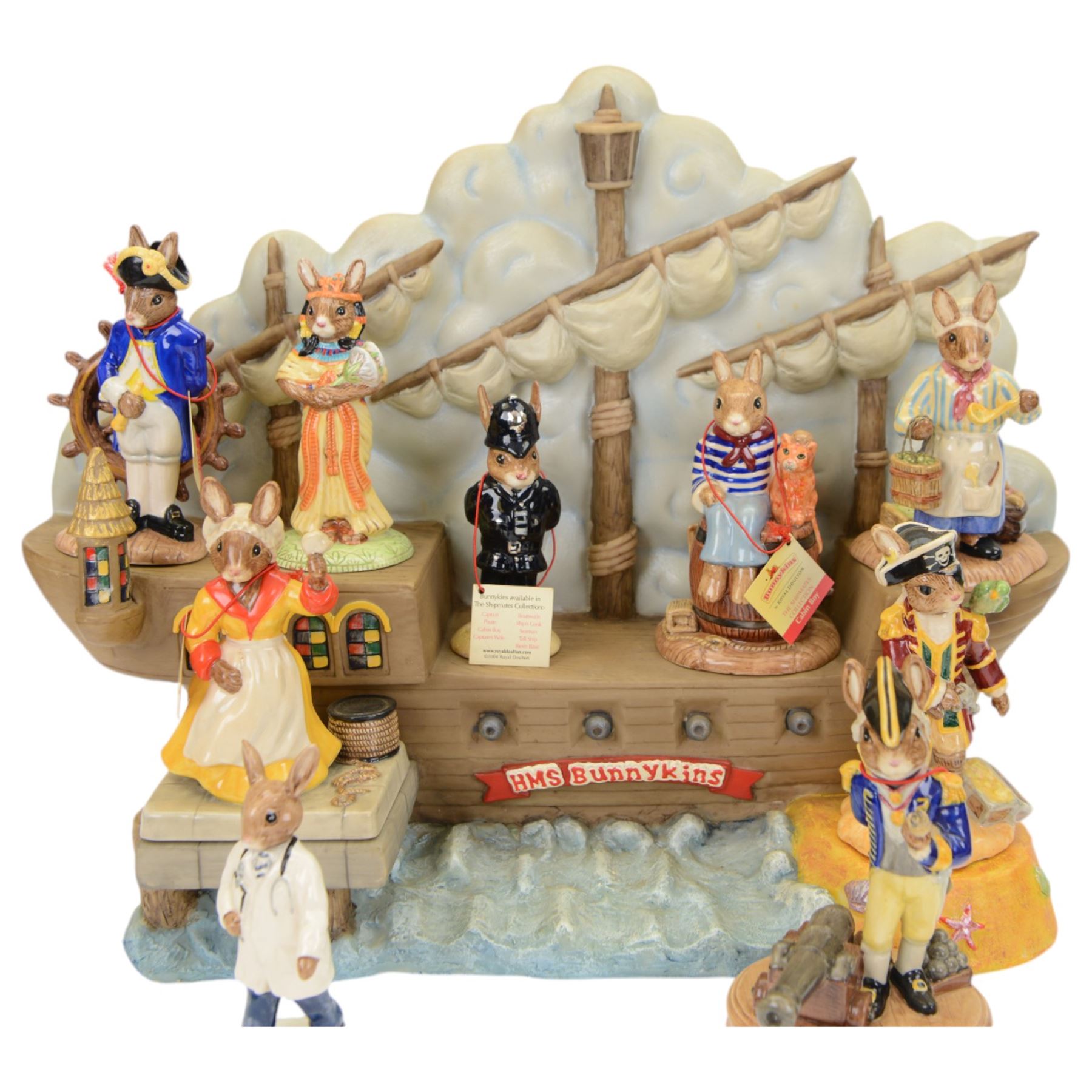 Royal Doulton Bunnykins,  six figures Shipmates Collection together with HMS Bunnykins display stand, together with three other figures 