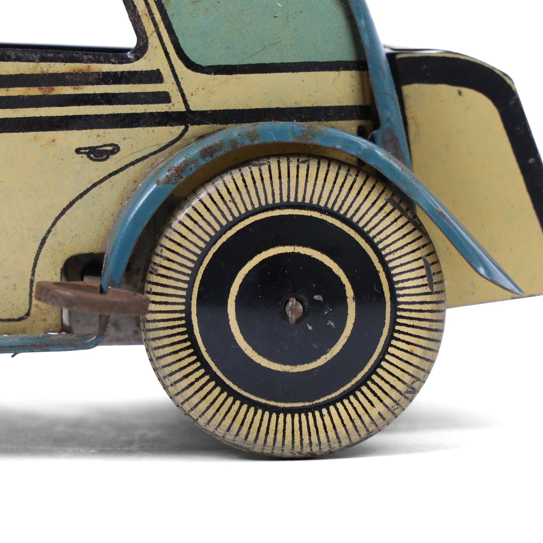 Wells tinplate clockwork limousine, the cream body, with blue roof and lithographed details, with driver and key, H8cm, L23cm