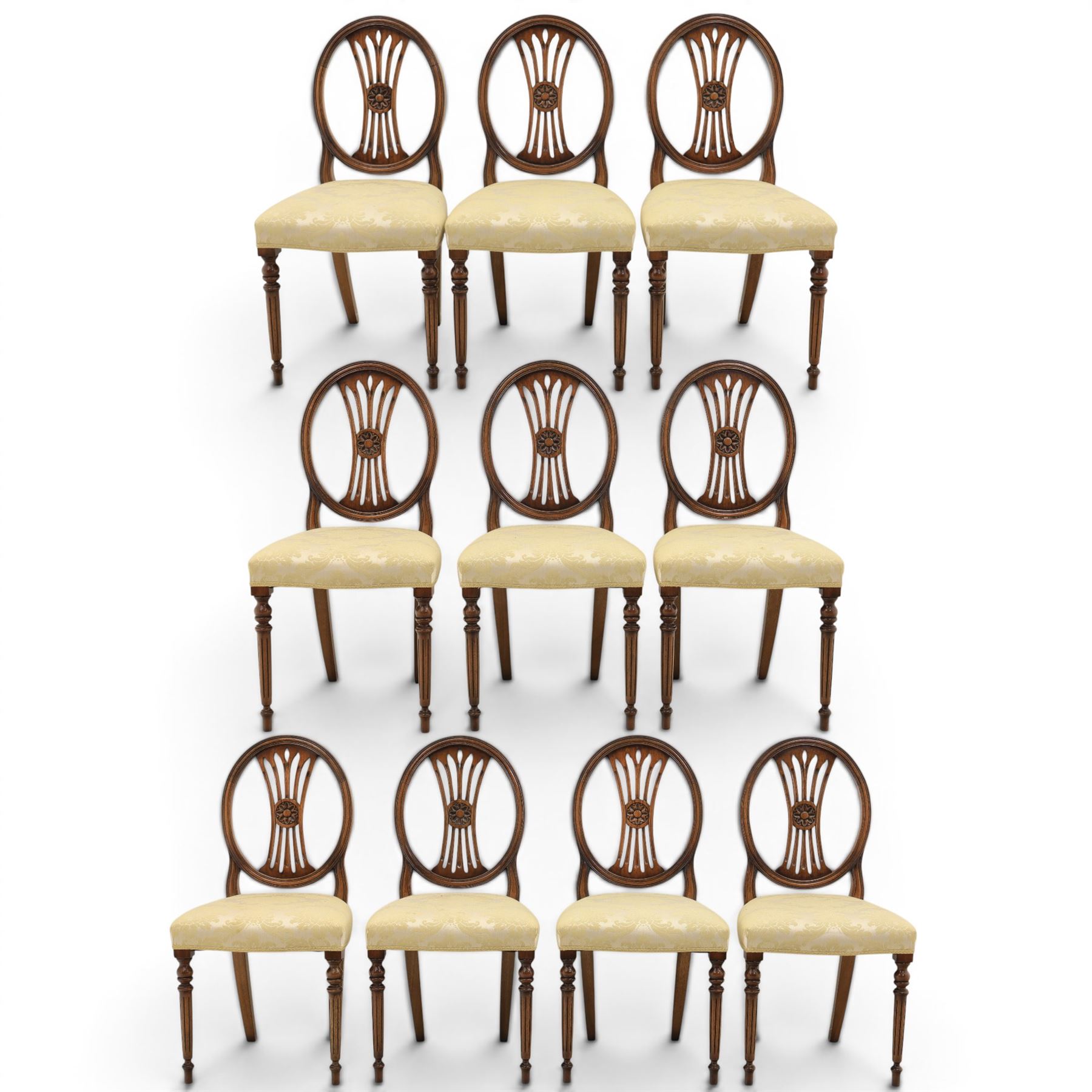Bevan Funnell Reprodux - Regency design set of ten mahogany dining chairs, oval backs with central splat with rose motif, serpentine seat upholstered in damask fabric, raised on turned supports