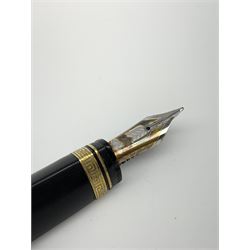 An Omas 360 fountain pen, the black triangular section body with gold coloured clip and banding, and Greek Key border to the cap, the bicolour nib marked 750 18K.