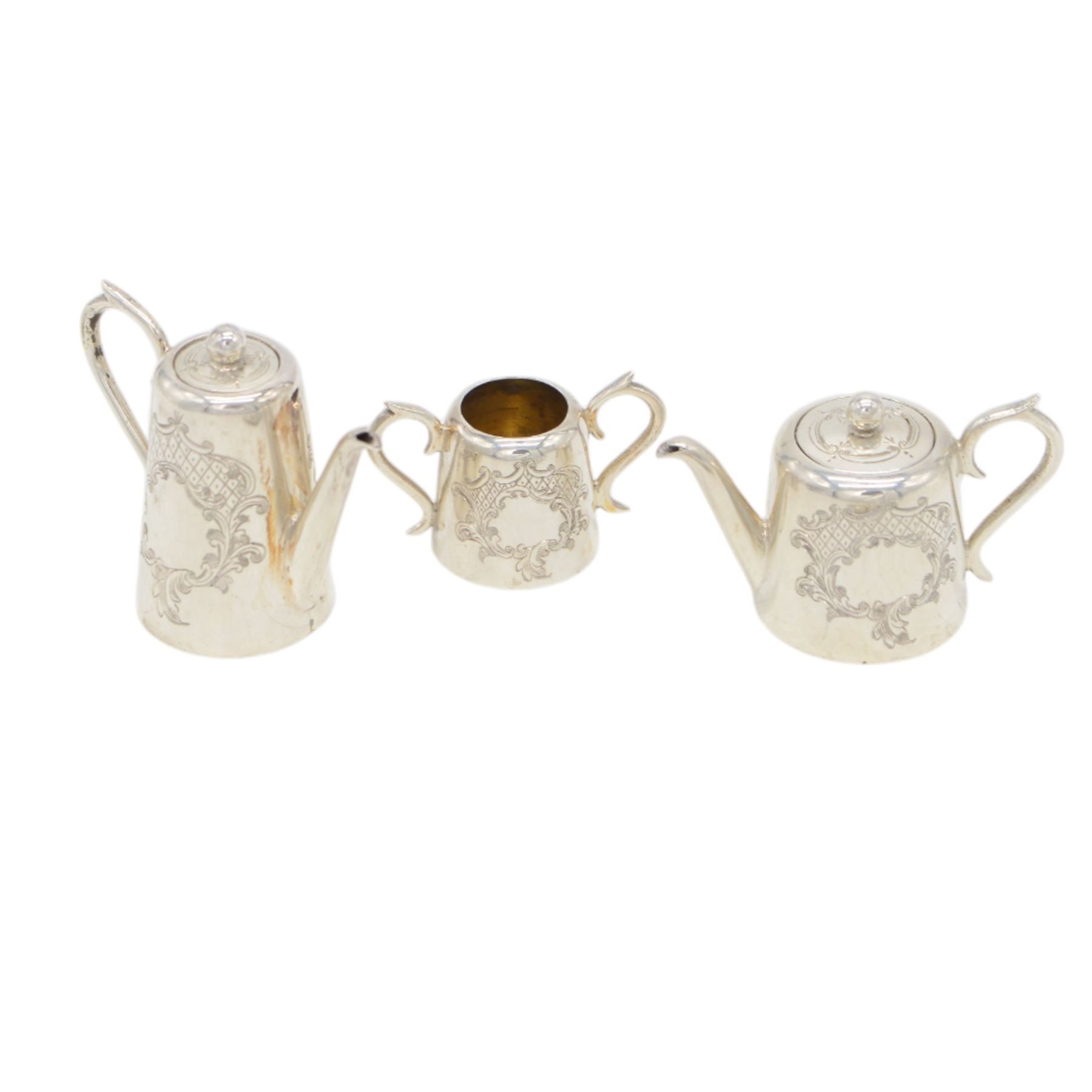 Edwardian miniature silver tea service, comprising tray, coffee pot, tea pot, milk and sugar bowl, all with engraved decoration, hallmarked J & J Maxfield Ltd, Sheffield 1903, together with a pair of miniature silver cups and saucers, hallmarked Cornelius Desormeaux Saunders & James Francis Hollings (Frank) Shepherd, Birmingham 1904, coffee pot H5cm