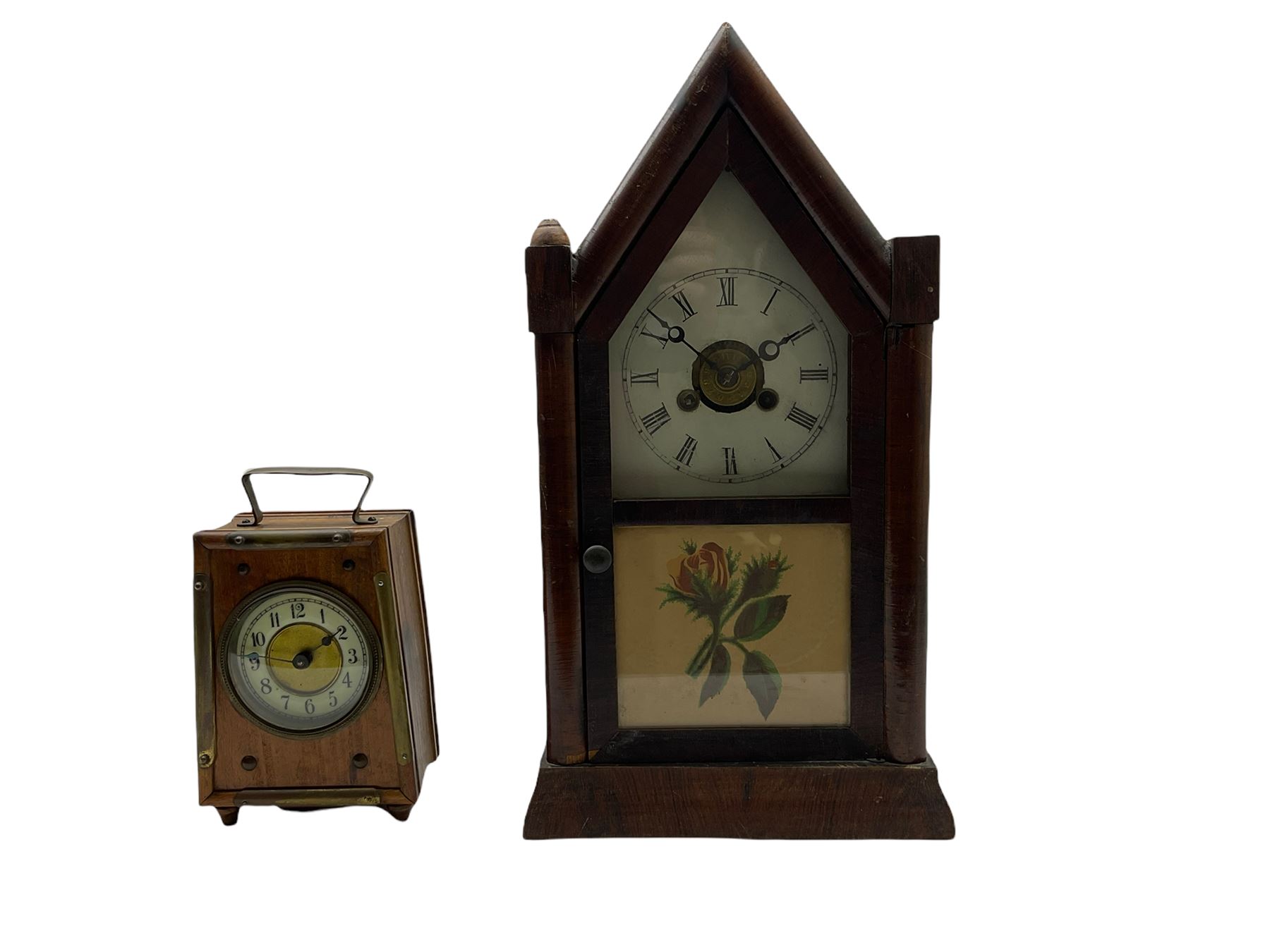 An American “Jerome” late 19th century  30-hour spring driven steeple clock with alarm, in a mahogany case with a decorative glass tablet depicting a rose painted white dial with roman numerals and minute track, steel moon hands and a brass alarm setting disc to the centre. With pendulum and key.
H40 W20 D10
With a small portable 19th century German “Wutternberg” alarm clock, the piece dial with a gilt centre and Ivorine chapter ring, Arabic hours and minute band, wooden case with brass fittings and carrying handle on four feet, wound and set from the rear with integral keys, alarm sounding on a bell. 
H20 W12 D7
