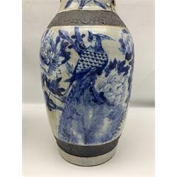 Pair of Chinese blue and white crackle glazed vases decorated with birds in blossoming branches with oxidised trim, H46cm