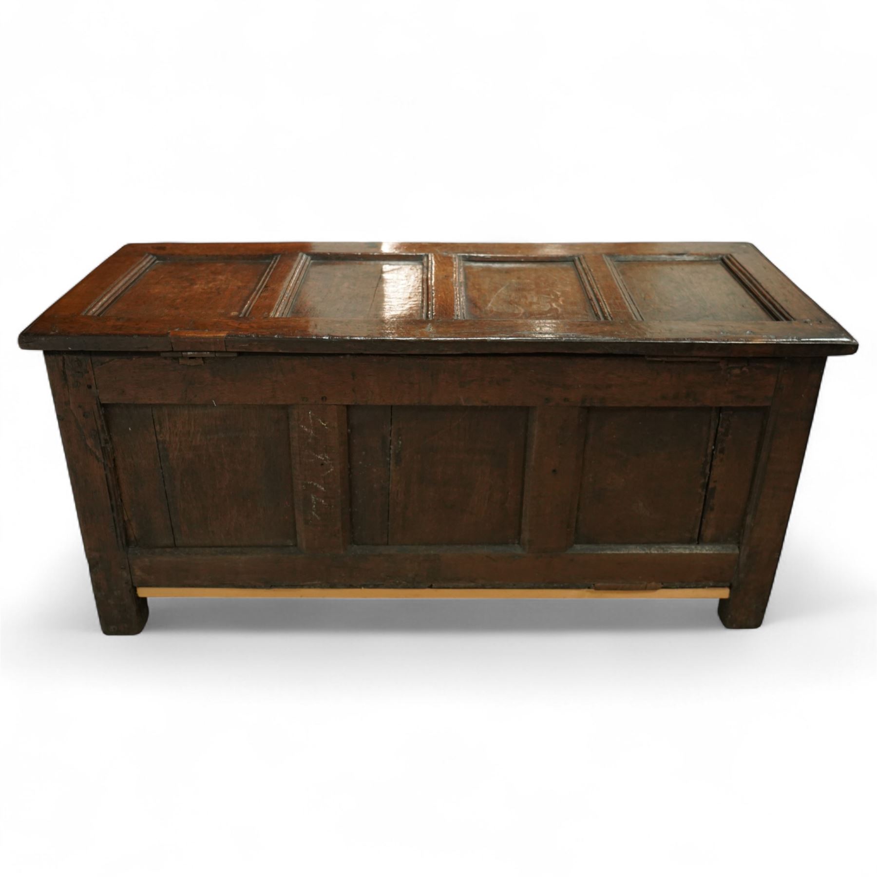 18th century and later oak coffer, the hinged plank top above a panelled front carved with lunette frieze, plain stiles and rails, carved with initials ‘AH’, pegged construction throughout