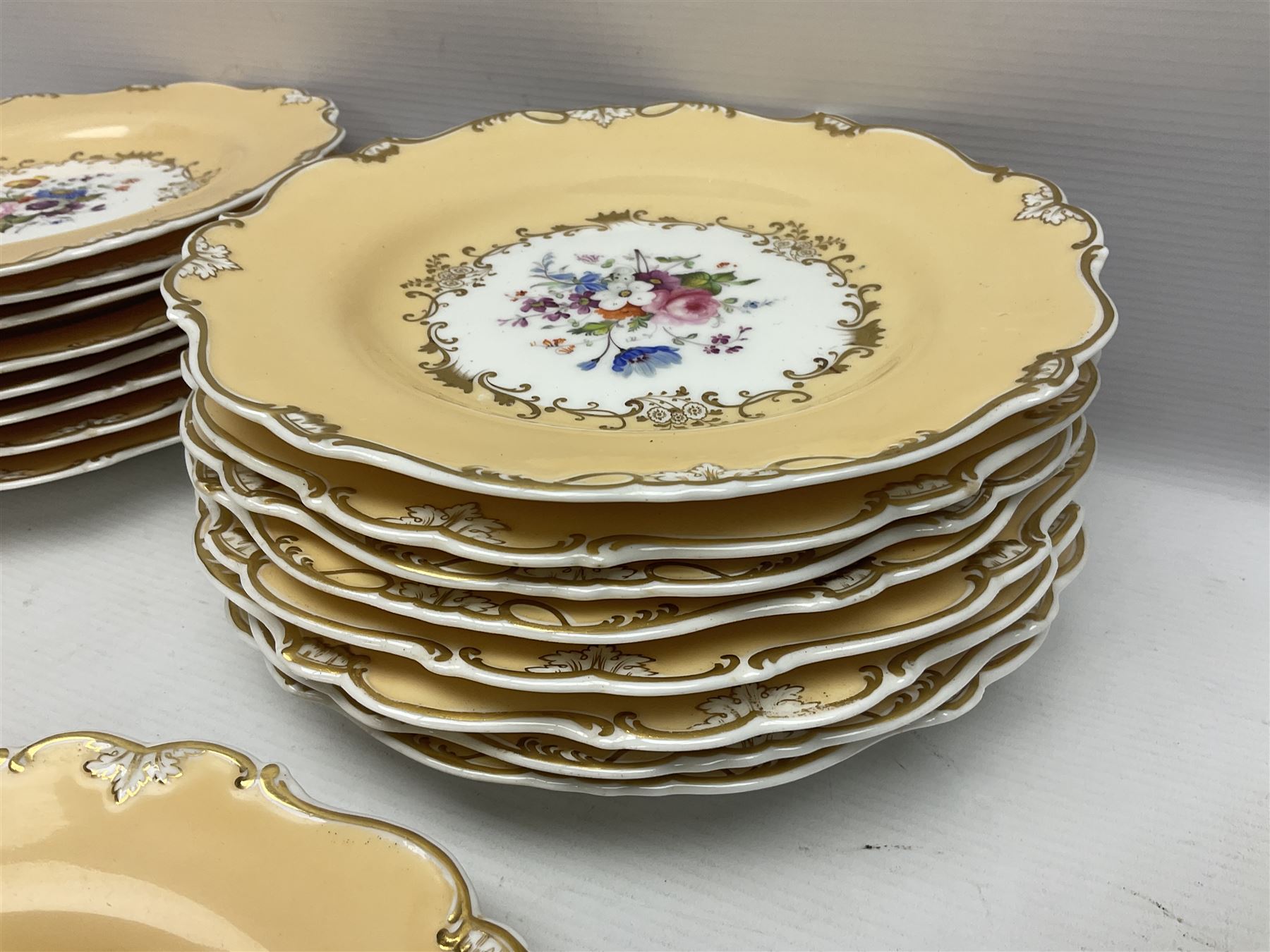 Victorian part dessert service, including eighteen plates, four small serving dishes, shallow dish, etc hand painted with floral sprigs within a cream border with floral panels, and heightened in gilt (26cm)