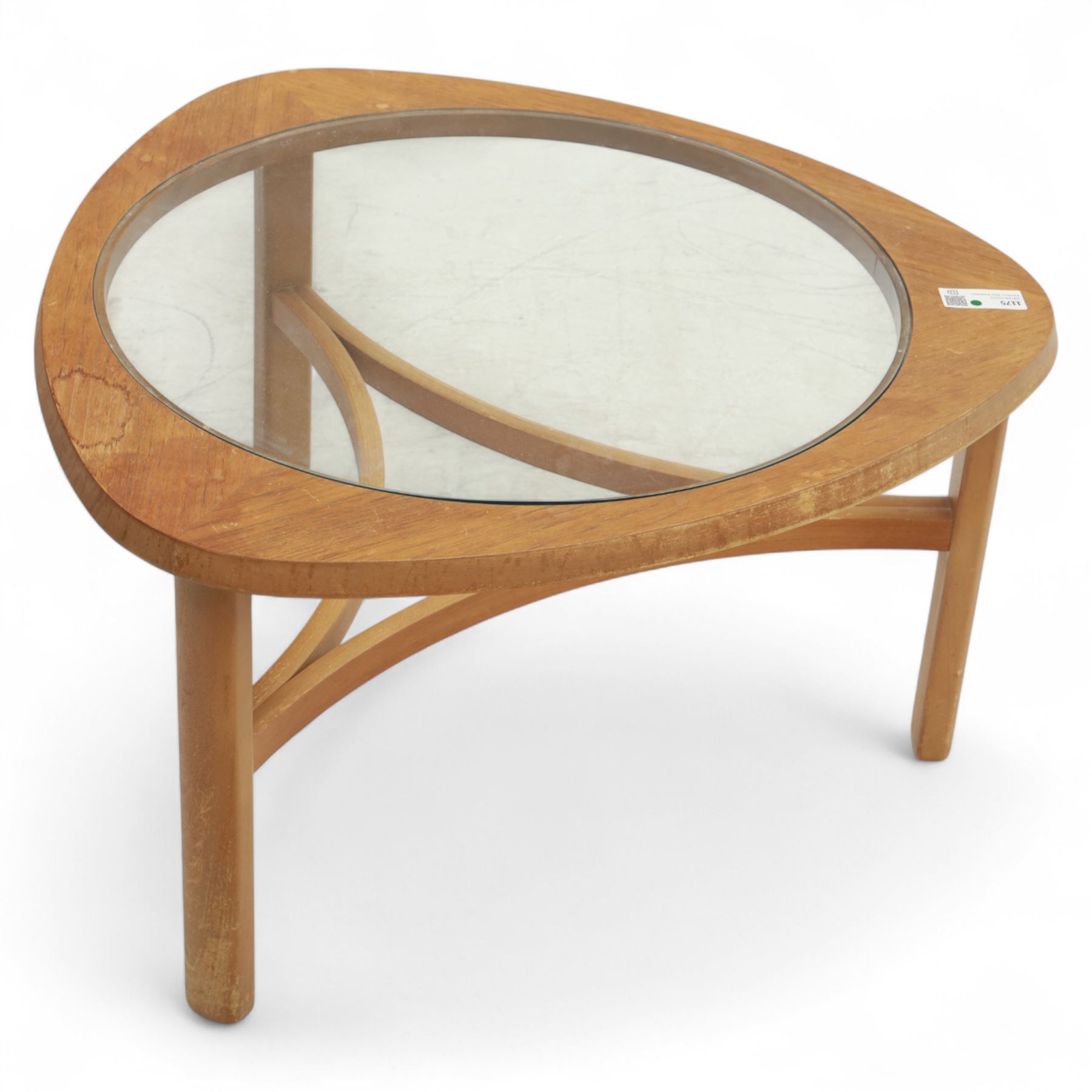 Mid-20th century teak and glass coffee table, of triangular form with rounded corners, inset circular glass top over curved stretcher base