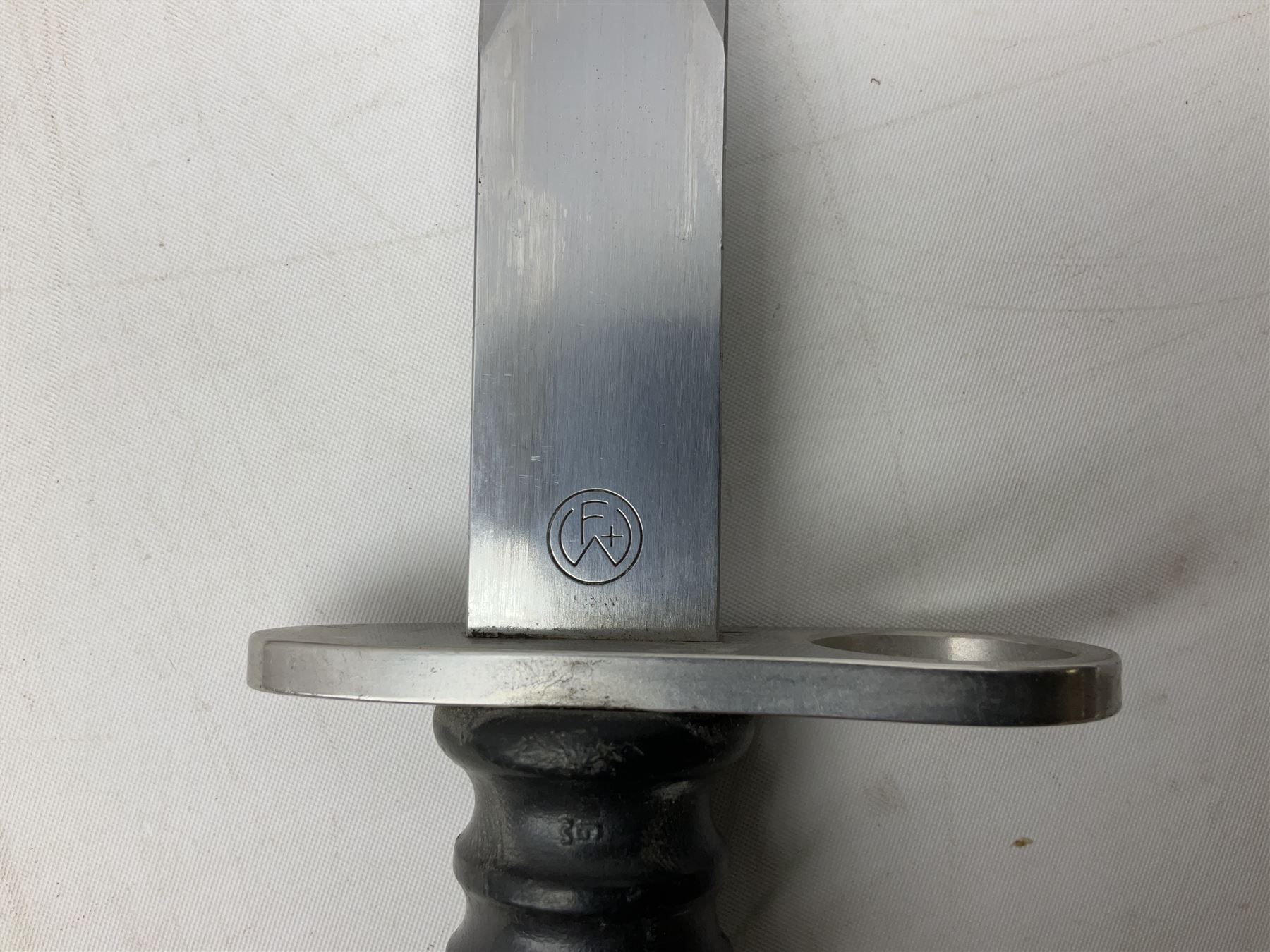 Schmidt-Rubin Model 1918 bayonet, the 30cm steel blade marked Elsener Schwyz, cross-piece numbered 813558; in steel scabbard with leather frog stamped E. Banga Sattler Selzac 67 L45.5cm overall; and Swiss Model 1957 SIG rifle bayonet by Wenger; in plastic scabbard with leather frog stamped E. Walty Sattlerei Baretswil 84 (2)