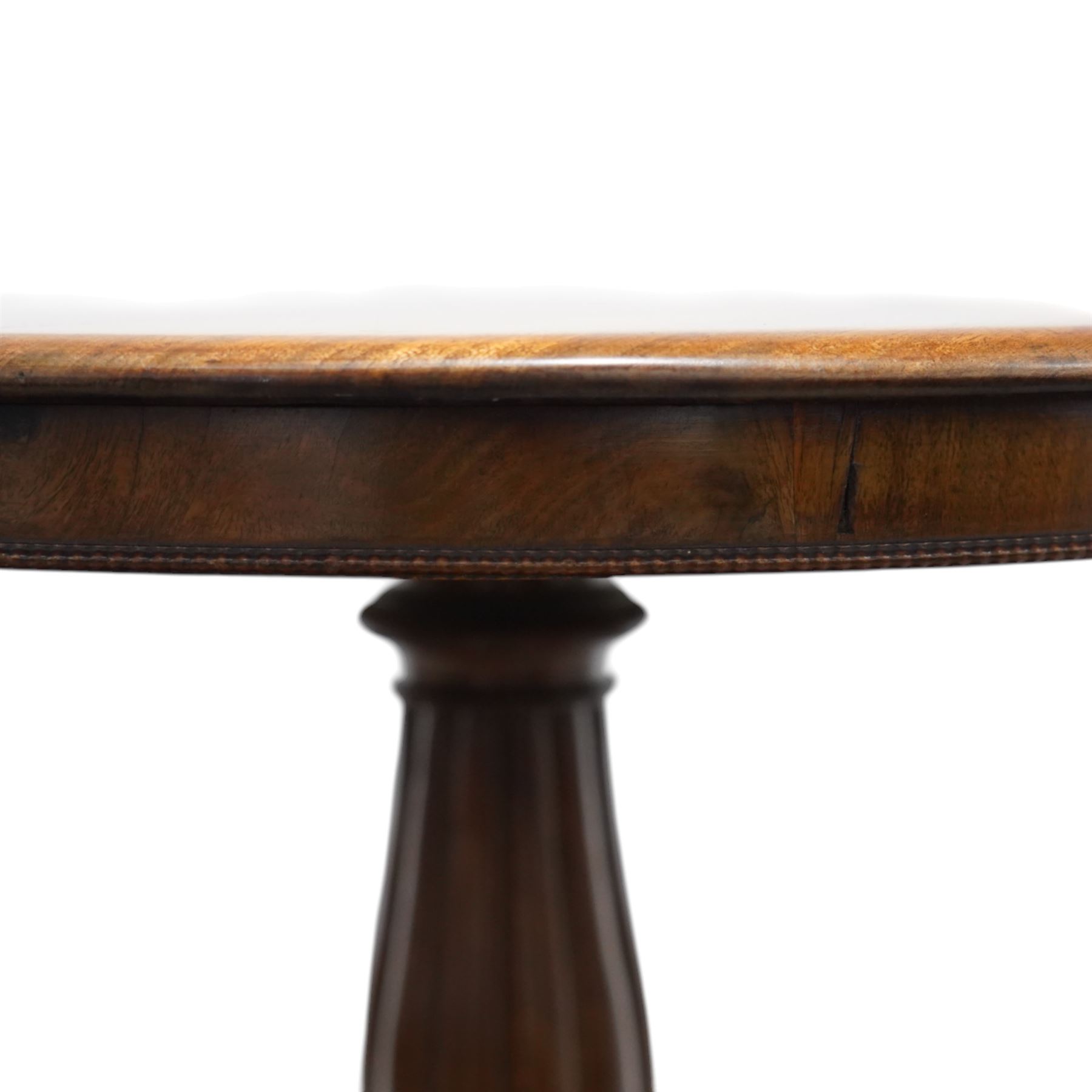 19th century mahogany centre table, with circular tilt top on a turned and reeded column, raised on three carved cabriole legs terminating in paw feet