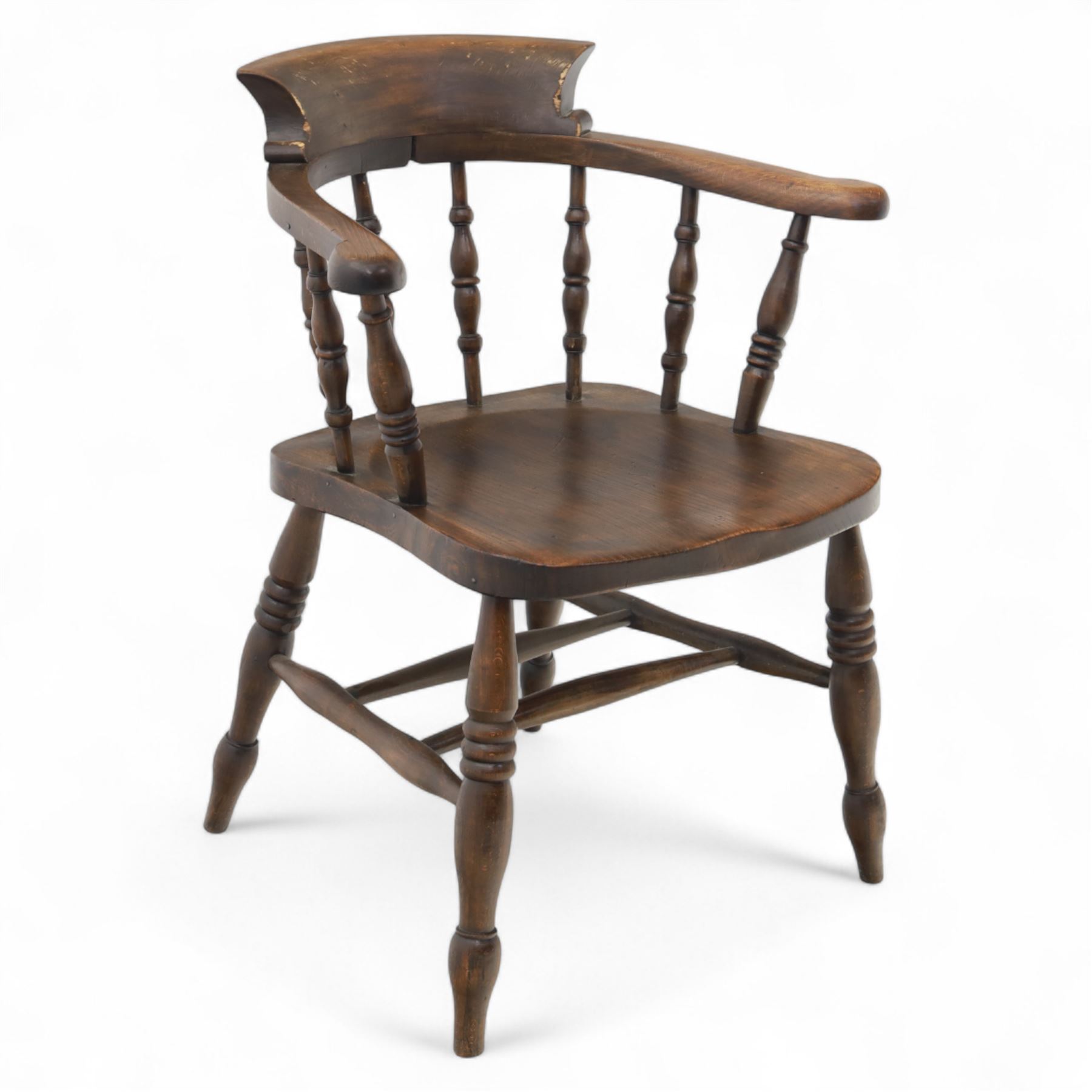 Early 20th century smokers bow armchair, shaped and curved top rail over turned spindles and open arms with rounded terminals, shaped elm seat on turned supports
