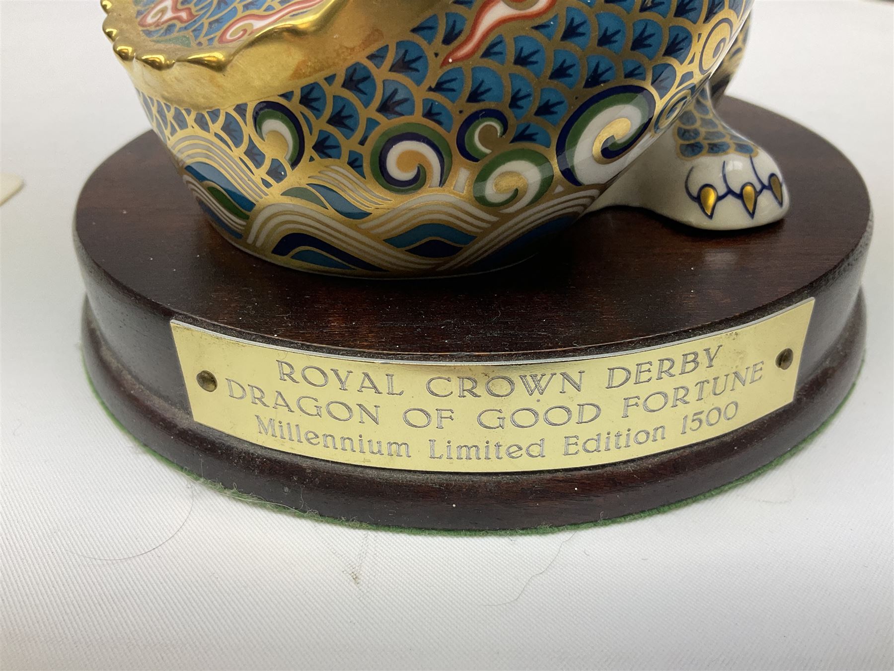Two Royal Crown Derby paperweights, Dragon of Happiness, limited edition 1227/1500 and Dragon of Good Fortune, limited edition 1227/1500, both with gold stopper, hardwood base, certificate and with printed mark beneath