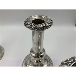 Four George III silver candlesticks, each upon knopped stem and weighted circular stepped foot, the foot and removable sconce repousse decorated with a band of flower heads, hallmarked to sconce and foot Thomas & John Settle, Sheffield 1820, H17.5cm