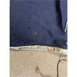 Ship's house flag, rectangular linen flag, with a white diamond and red cross to the centre, upon a cobalt blue ground, inscribed on the hoist 'Cutty Sark', H130cm, W170cm

Provenance by vendor repute: Vendor's father was a naval cadet in 1940s/50s on board HMS Worcester which was moored alongside the Cutty Sark on the River Thames at Greenhithe. He has had the flag since then. 