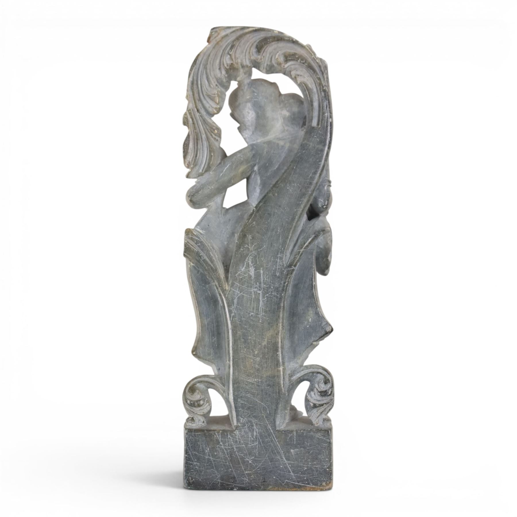 Stone carving of goddess, together with material with gold thread decorated with stylised flowers 