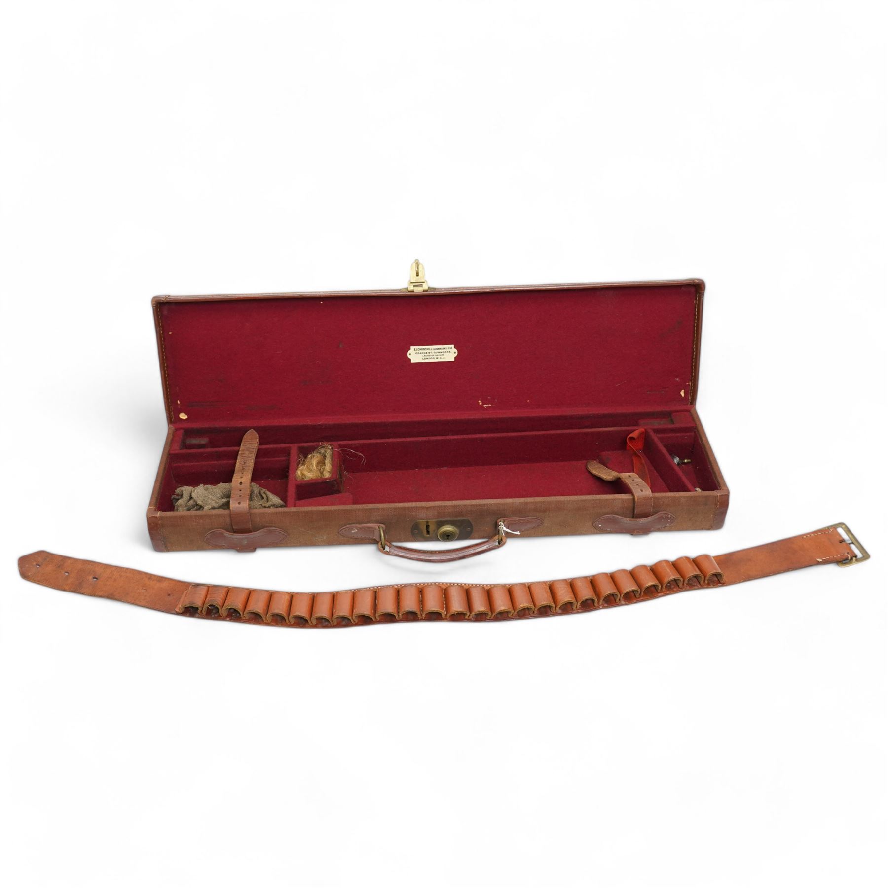 Churchill canvas shot gun case with leather corners and baize lined interior with trade label 'E J Churchill (Gunmakers ) Ltd ' with cleaning rods  and a leather 12 gauge cartridge belt