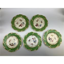 19th Century and later, Minton style tea and dessert wares, centrally decorated with a spray of flowers within green and gilt decorated borders, comprising two tea cups, saucer, three comports, one square serving dish and ten dessert plates, together with a pair of matching vases. 