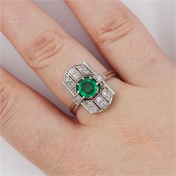 Art Deco 14ct white gold emerald and diamond panel ring, the central round cut emerald of approx 0.45 carat, within a pierced octagonal setting, flanked by a single cut diamond either side and three rows of milgrain set, single cut diamonds, to a reeded shank, stamped 585, total diamond weight approx 0.55 carat