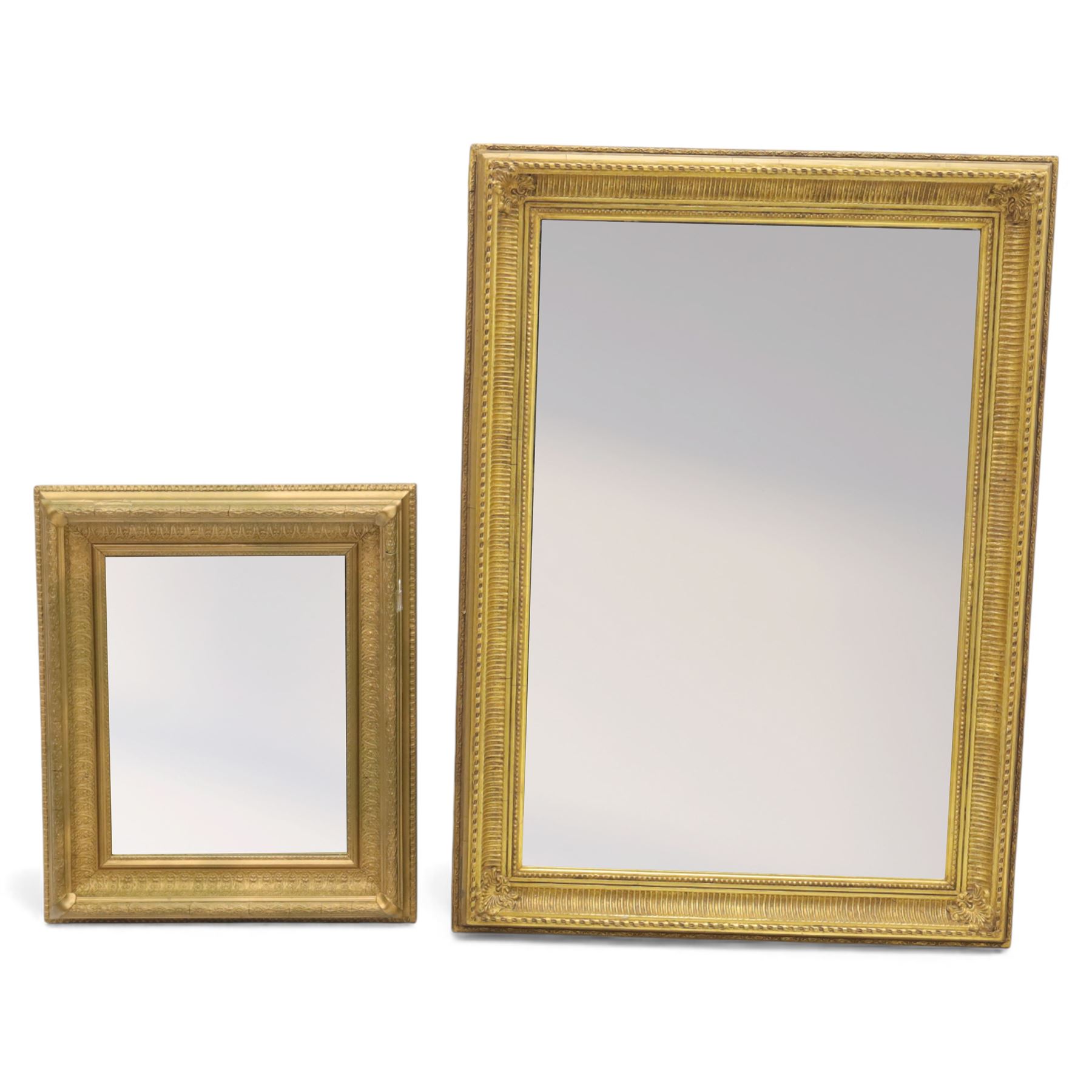 Two late 20th century gilt mirrors, foliate and dart detailing to the frame (H 92cm, W 66cm; H 53cm W 45cm)