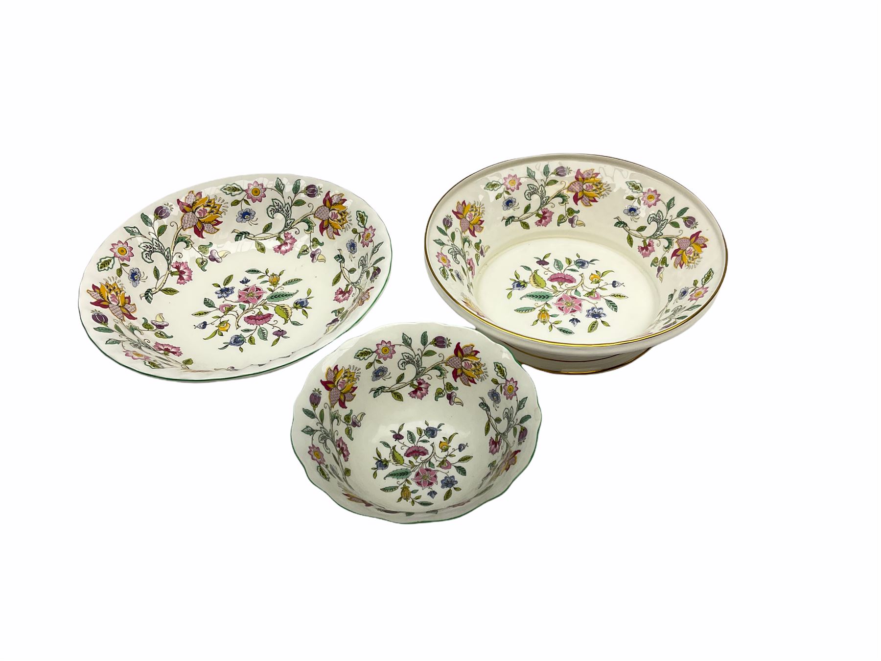 Minton Haddon Hall pattern tea and dinner wares, including basket dish, two covered tureens, six dinner plates, eight dessert plates, twelve tea plates, six soup bowls, six cereal bowls, teapot, coffee pot, milk jug, covered sucrier twelve tea cups and saucers, six mugs, footed bon bon dish, pair of candlestick holders, cake knife and slice etc (81)