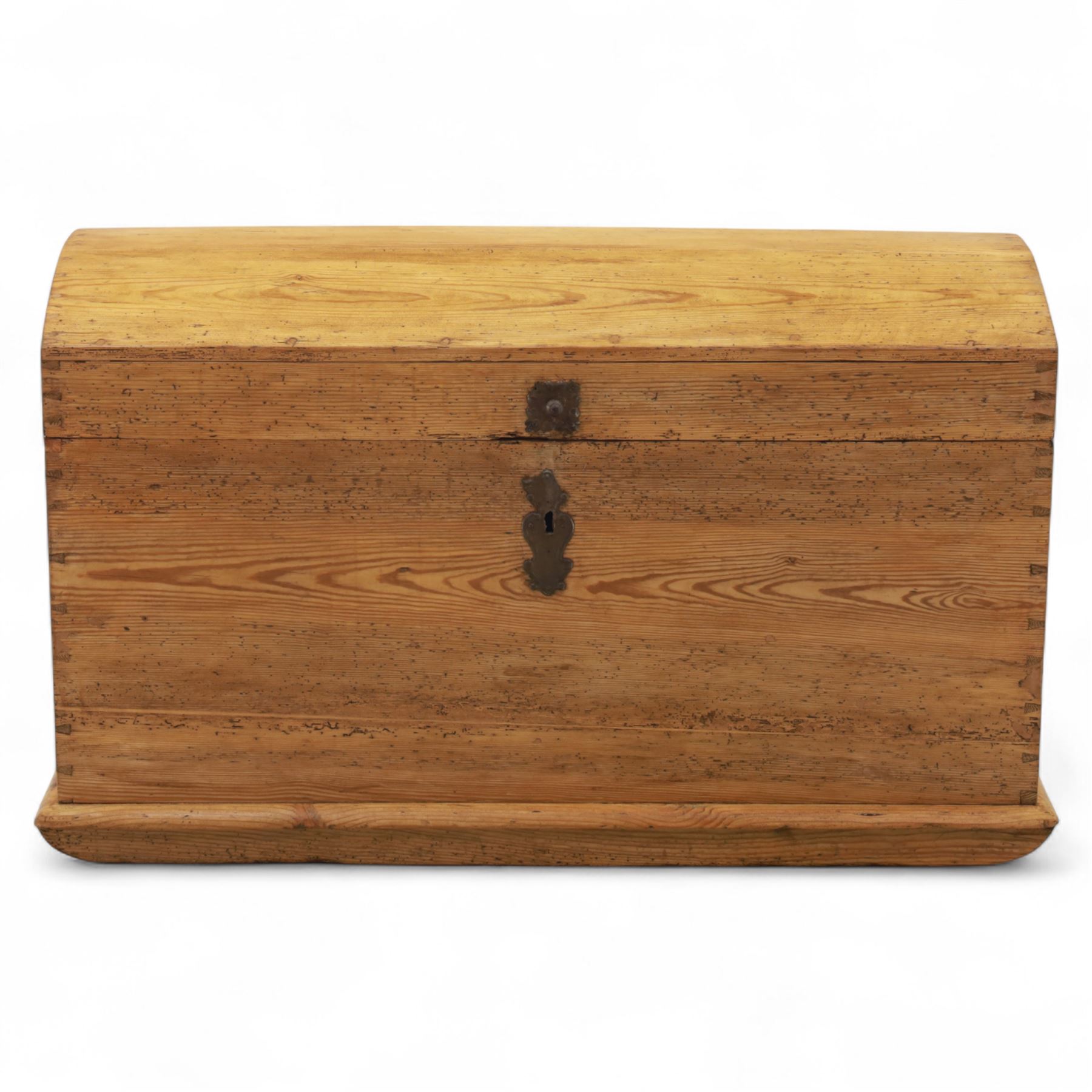 Early 20th century pine coffer, domed lid over plain front and sides with exposed dovetail joints, iron hasp and staple to front