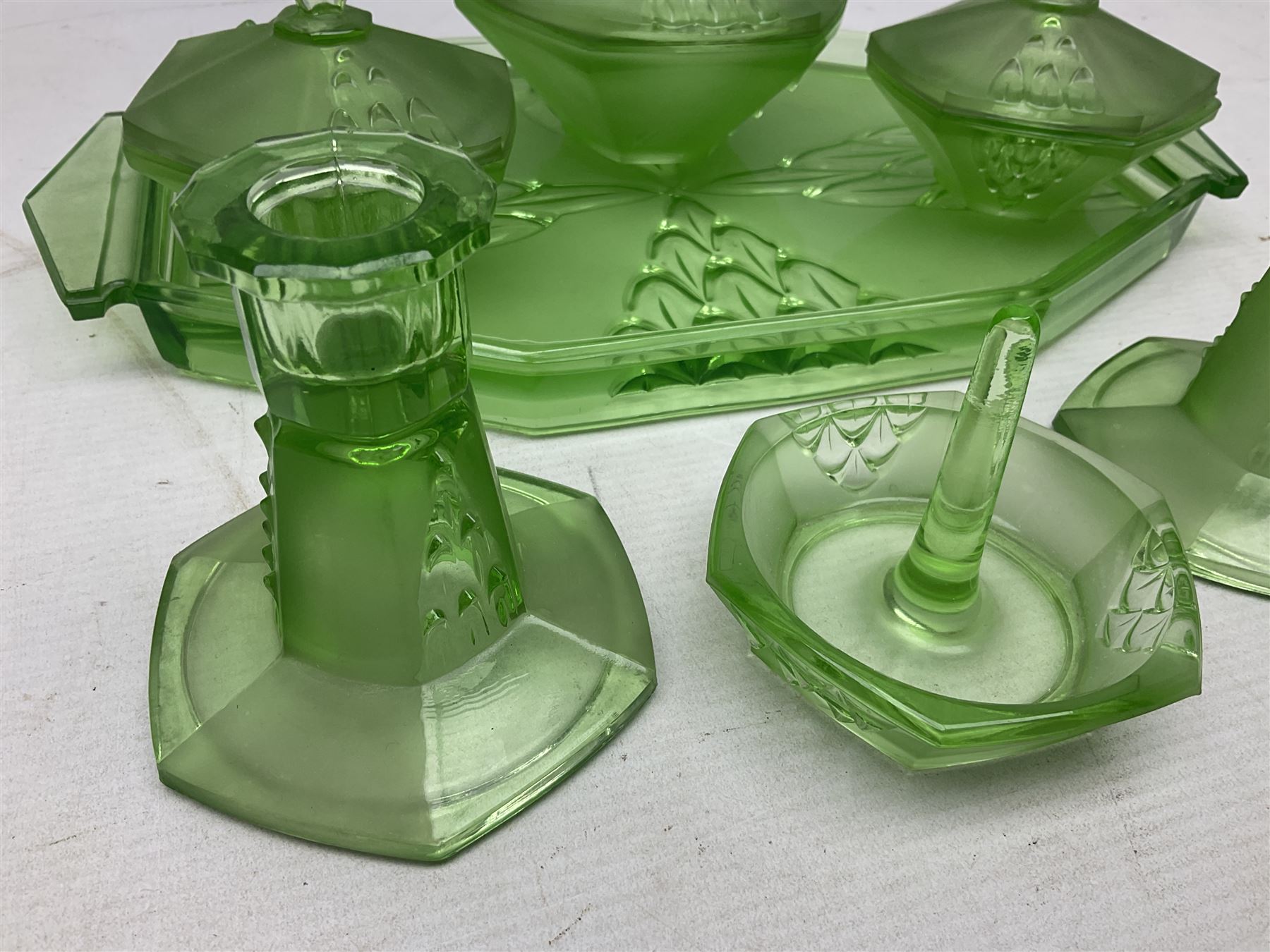 Czech uranium glass dressing table set, comprising twin handled tray, pair of candlesticks, three lidded jars and ring holder dish, and a blue Finnish Riihimäki glass, tray L35cm