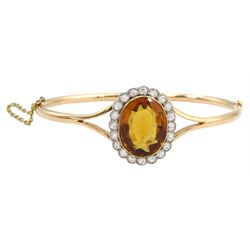 Early 20th century 15ct rose gold oval citrine and milgrain set old cut diamond hinged bangle, total diamond weight approx 1.10 carat