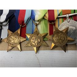 WW2 Royal Naval group of eight medals comprising OBE, hallmarked silver Distinguished Service Cross inscribed verso Lieut. J.R. McCluskie RNVR 1945, 1939-1945 Star, Atlantic Star, Africa Star, 1939-1945 War Medal, Defence Medal and Royal Naval Patrol Service Medal inscribed Lieutenant J.R. McCluskie Royal Naval Patrol Service; with seven original photographs of a sea battle 27th November 1940 against the Italian Fleet and another photographic postcard of Sir Stafford Cripps arriving on board one of the vessels.